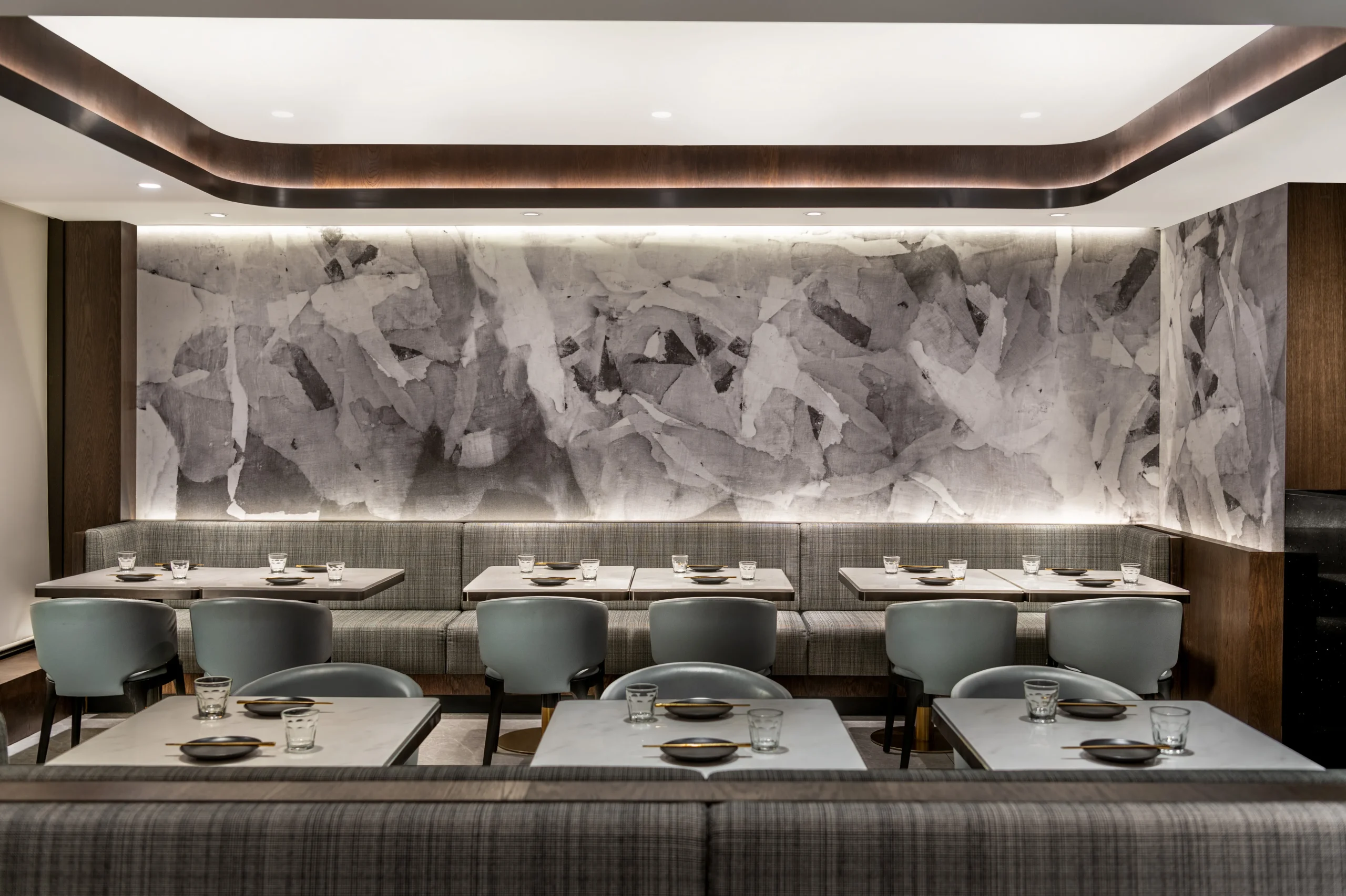 Interior Design - Interior dining area featuring gray textured wall and modern seating arrangements. Dexign Matter Studio