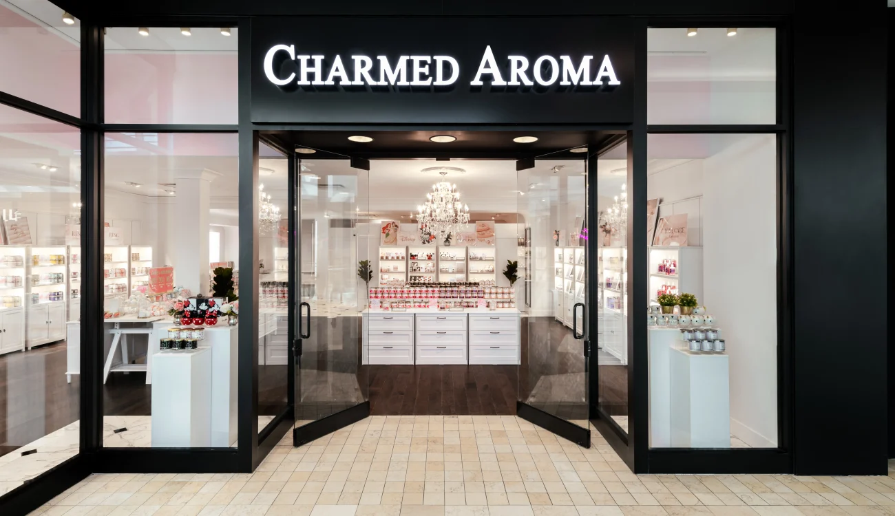 Interior Design - Storefront of Charmed Aroma featuring a modern design with glass doors and a chandelier. Dexign Matter Studio