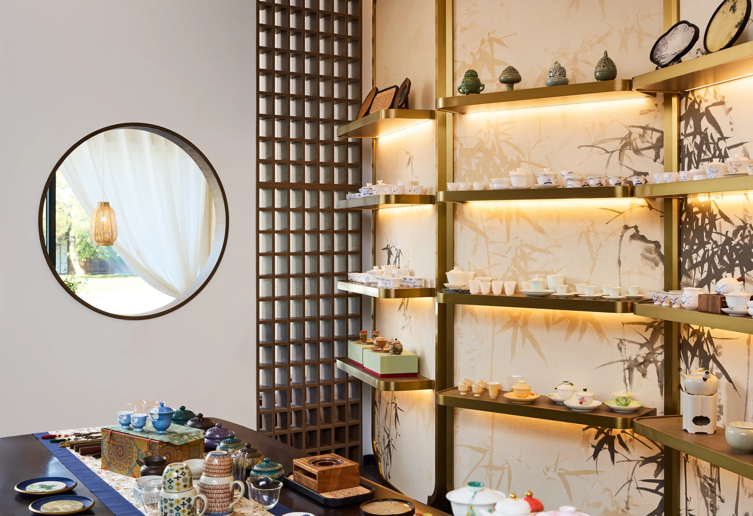 Interior Design - Display of various tea accessories and teapots arranged on shelves in a modern setting. Dexign Matter Studio