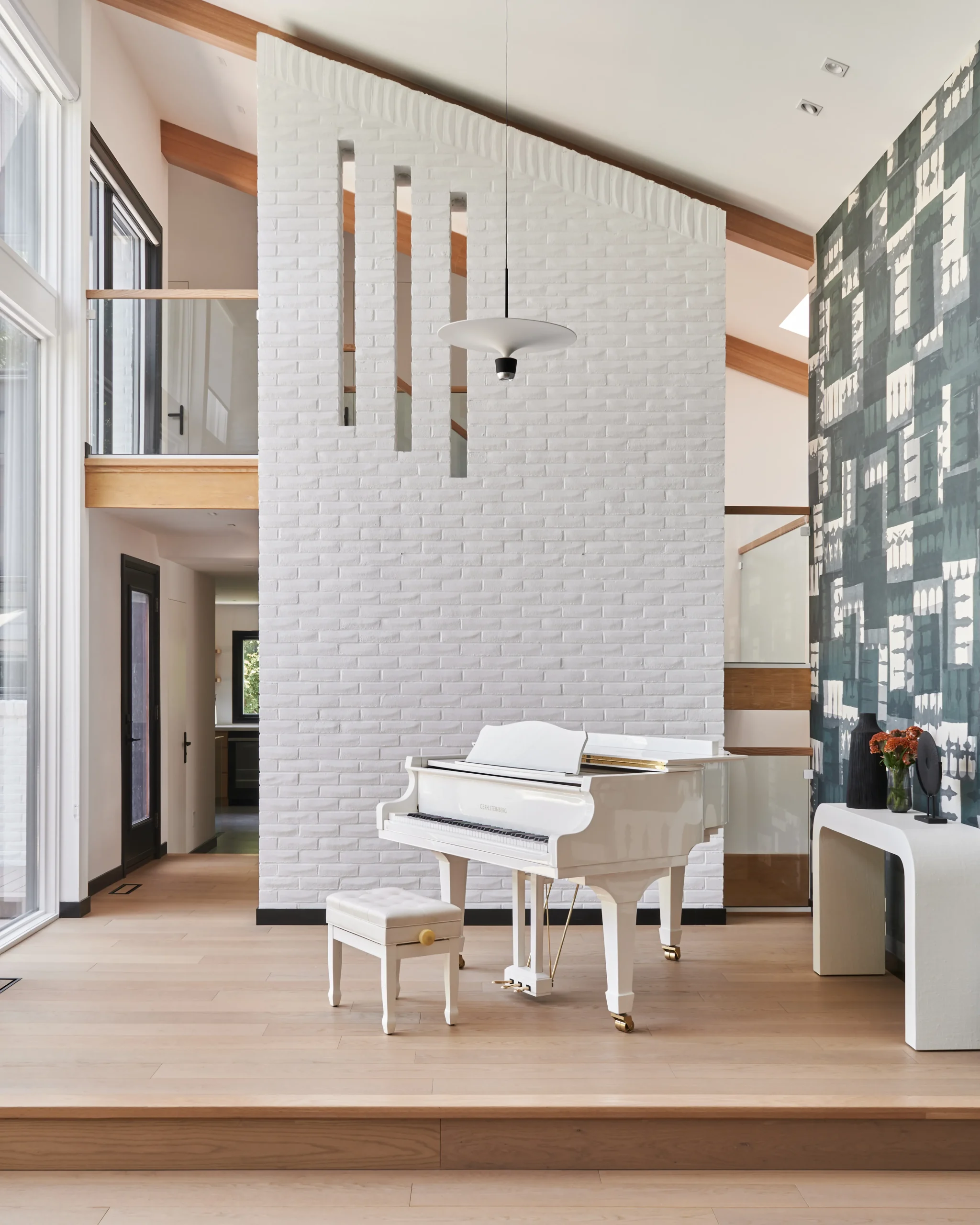 Interior Design - A white grand piano positioned in a modern interior space with wooden flooring. Dexign Matter Studio