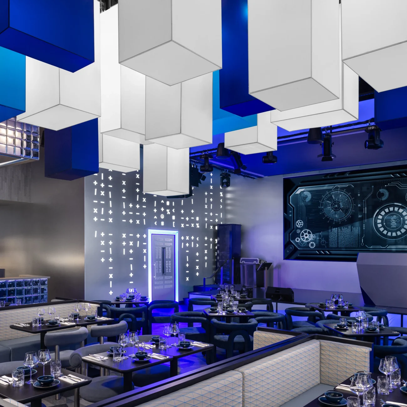 Interior Design - Interior view of a modern restaurant featuring blue and white decor with geometric hanging lights. Dexign Matter Studio
