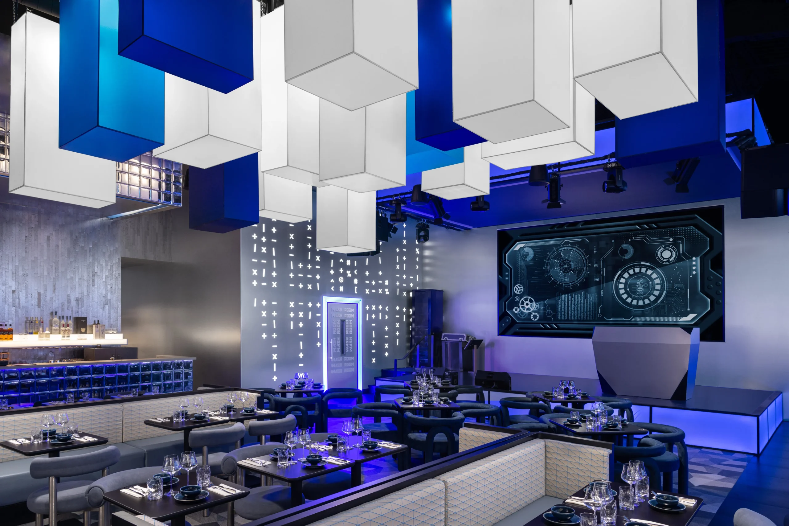 Interior Design - Interior view of a modern restaurant featuring blue and white decor with geometric hanging lights. Dexign Matter Studio