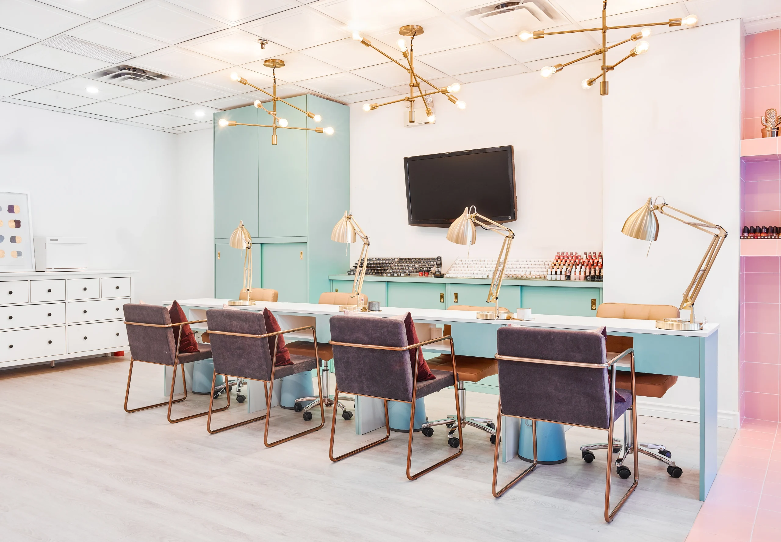 Interior Design - Interior view of a nail salon featuring workstations with lamps and modern decor. Dexign Matter Studio