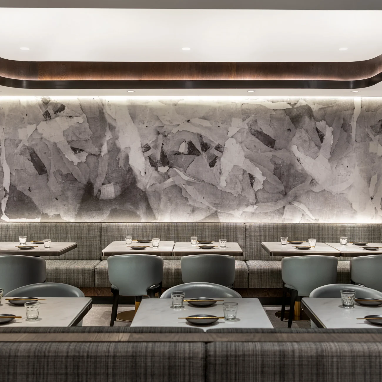 Interior Design - Interior dining area featuring gray textured wall and modern seating arrangements. Dexign Matter Studio