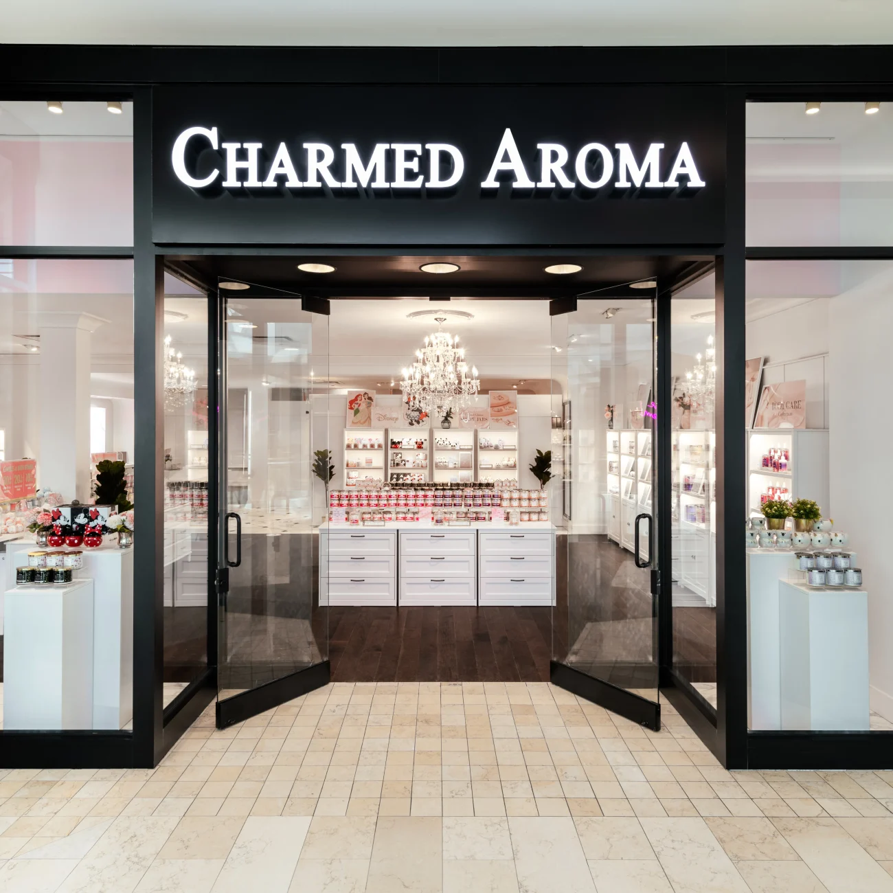 Interior Design - Storefront of Charmed Aroma featuring a modern design with glass doors and a chandelier. Dexign Matter Studio