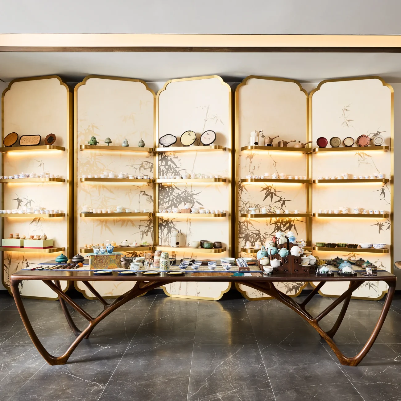 Interior Design - Interior view of a tea display featuring various tea products on shelves and a wooden table. Dexign Matter Studio