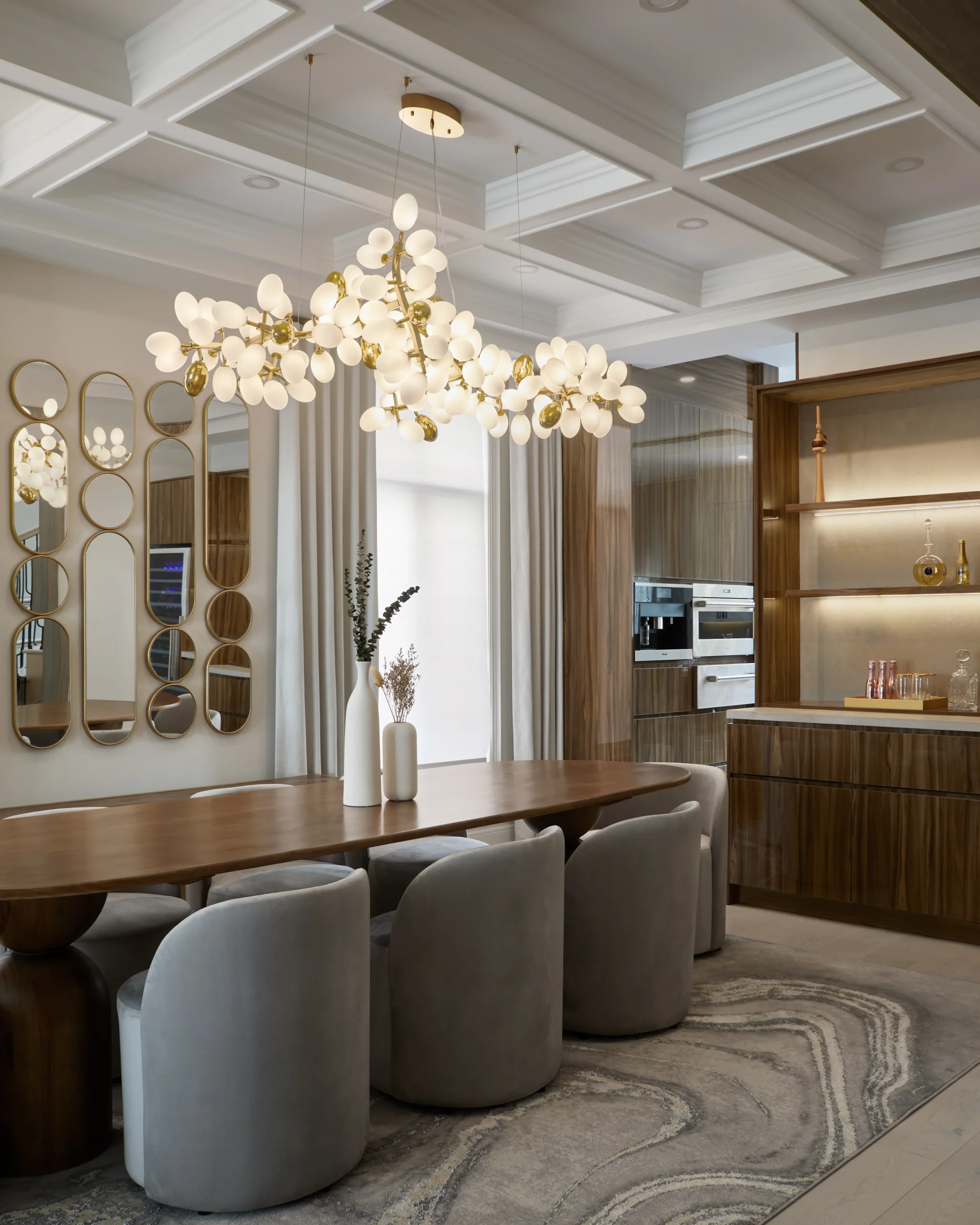 Interior Design - Contemporary dining room featuring a large wooden table and a unique chandelier with white bulbs. Dexign Matter Studio