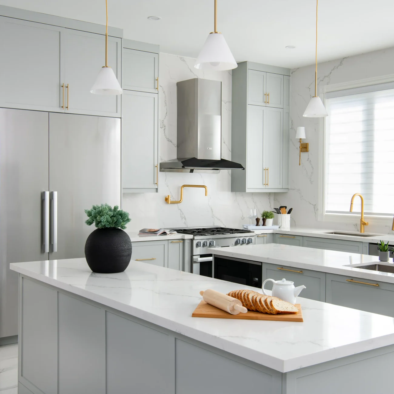 Interior Design - Modern kitchen featuring gray cabinets, marble countertops, and gold fixtures. Dexign Matter Studio