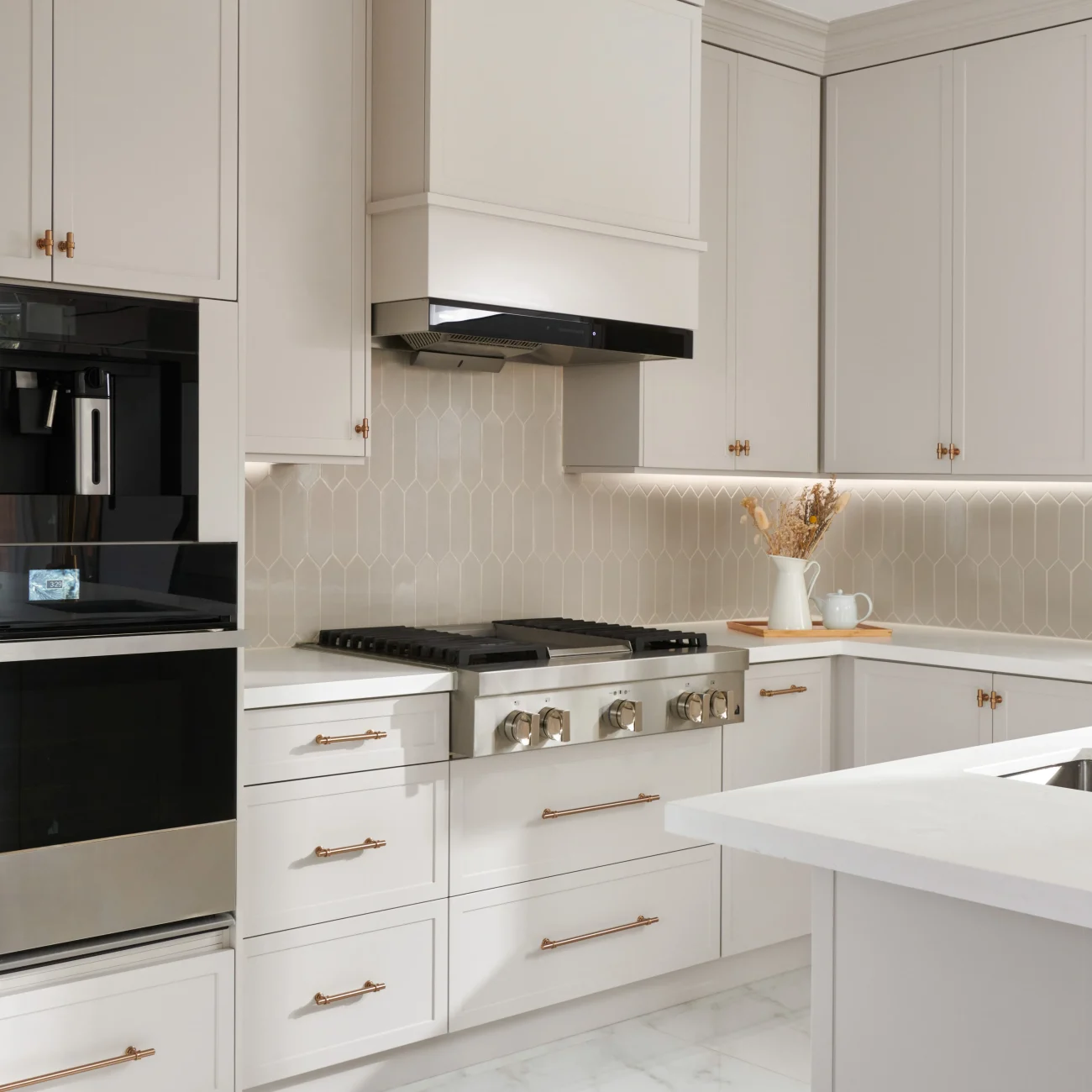 Interior Design - Modern kitchen featuring stainless steel appliances and light cabinetry with decorative hardware. Dexign Matter Studio